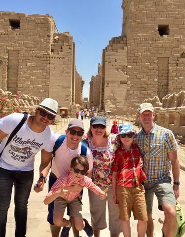 Group of people at an ancient Egyptian temple complex.