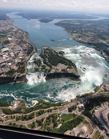 Aerial view of Niagara Falls surrounded by a cityscape.