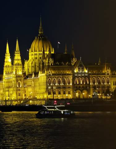 The Hungarian Parliament Building illuminated at night.