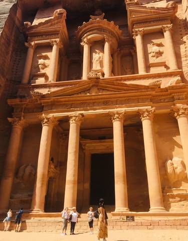 Facade of Petra's Al-Khazneh with intricate stone carvings.