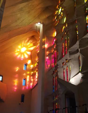 Colorful sunlight filtering through stained glass windows inside a church.