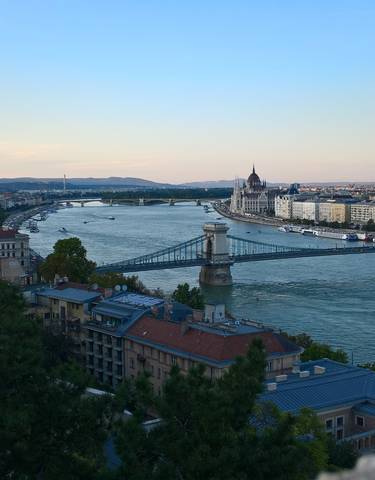Scenic view of the Danube River with a bridge and cityscape.