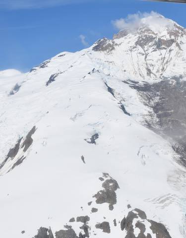Snow-covered mountain peak under a clear blue sky.