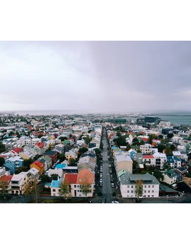 Panoramic view of colorful city buildings and harbor.