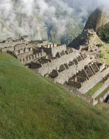 Aerial view of Machu Picchu ruins with surrounding mountains.