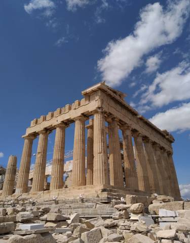 The Parthenon under a clear blue sky.