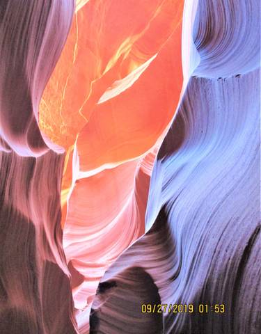 Colorful and abstract view of canyon walls with glowing light.