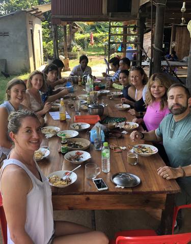 Group enjoying a meal around a table.