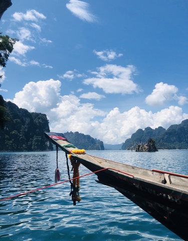 Longtail boat in a stunning lake setting.