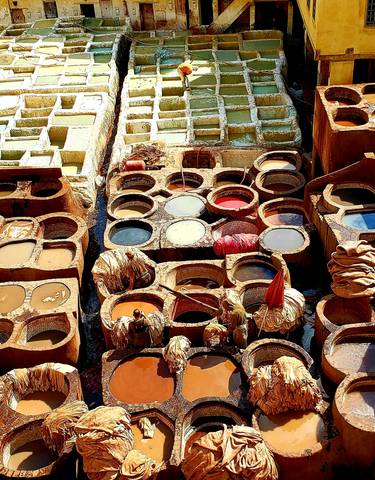 A vibrant image of traditional dye vats used for leather tanning.