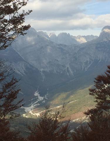 Mountain range with a valley and river below.