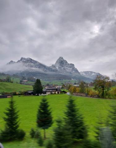Snow-capped mountain with a village in the foreground.