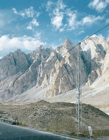 A scenic view of rugged mountains and road in Hunza Valley, Pakistan.