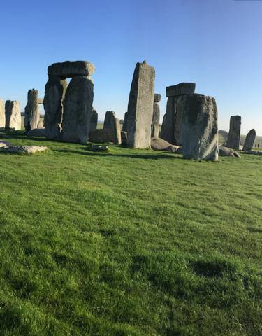 Stonehenge rock formation on a grassy landscape.