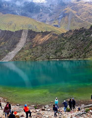 Crystal-clear turquoise lake surrounded by mountains.