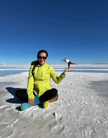 Person at Uyuni Salt Flats performing a perspective trick.