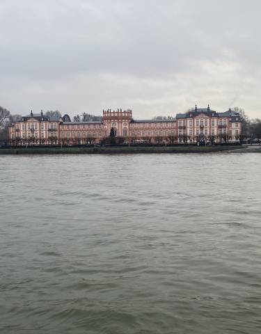 Large building with river in the foreground.