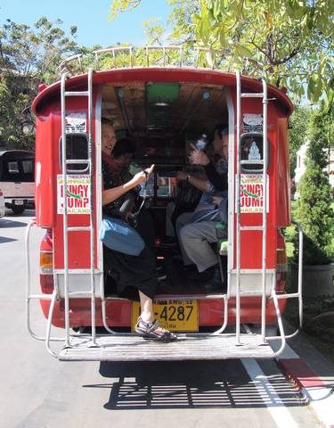 Tourists enjoying a ride in a red tuk-tuk