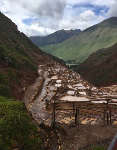 Terraced salt evaporation ponds in a mountainous region.