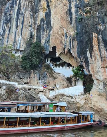 Cave entrance with steps and flags.