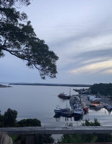 Harbor view with boats and a cloudy sky.