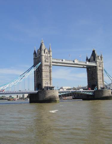 Tower Bridge over the Thames with a clear blue sky.