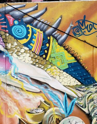 Colorful graffiti mural featuring an iguana and astronaut.