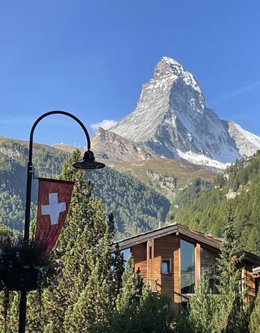 View of the Matterhorn mountain with Swiss flag.