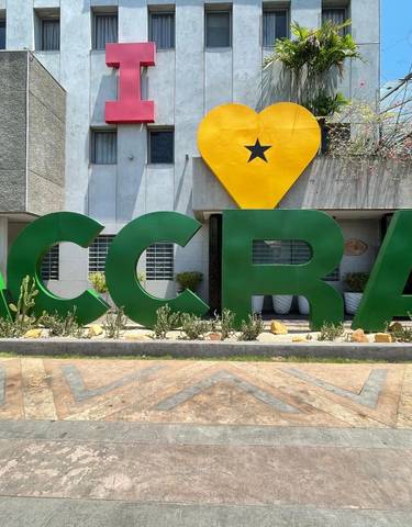 Large sign spelling 'ACCRA' in front of a building.