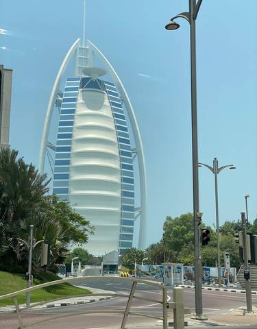 Famous sail-shaped hotel building surrounded by greenery.