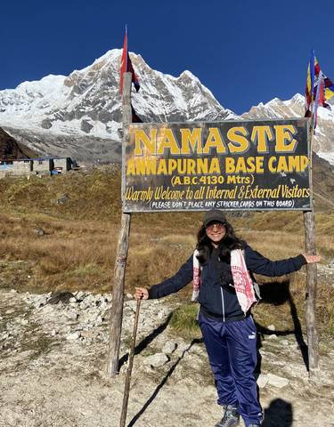 Person holding a sign at Annapurna Base Camp.