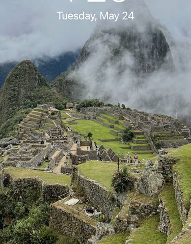 Scenic view of Machu Picchu surrounded by mist.