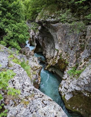 Stunning gorge with clear blue water flowing between rock formations