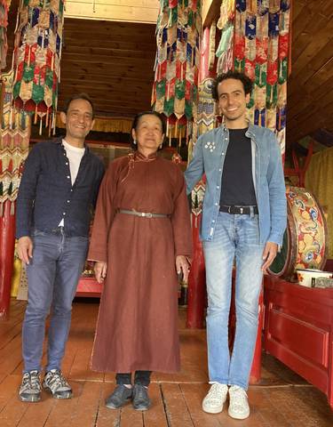 People standing inside a traditional Mongolian home