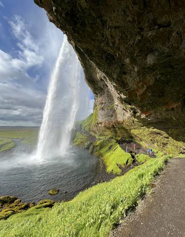 Waterfall with mist and tourists nearby