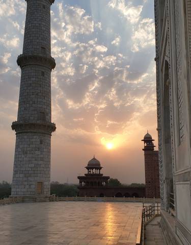 Sunset view from the Taj Mahal with silhouetted minarets.