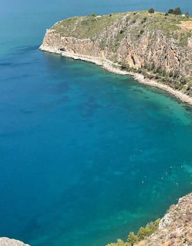 Beautiful aerial view of a shoreline with clear blue waters.