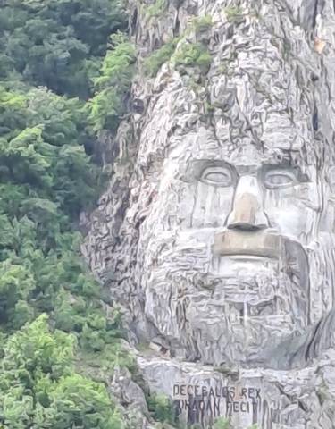 A large rock sculpture of a face in the mountainside.
