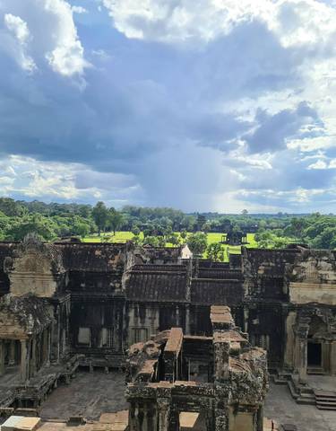 View through a temple opening overlooking ancient ruins.