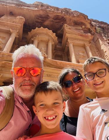 A family taking a selfie in front of Petra.