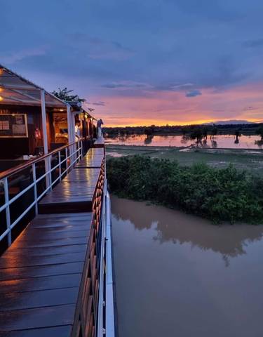 Sunset view from a boat overlooking floodplains.