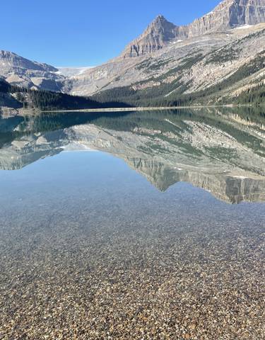 Crystal clear lake with mountain reflections.