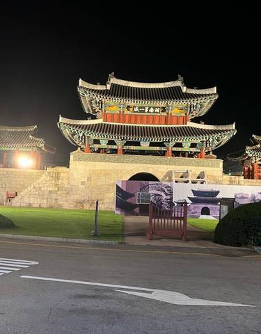 Traditional Korean building illuminated at night.