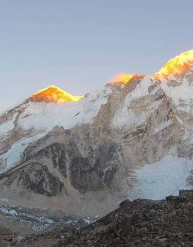 Snow-covered mountain peaks at sunset.