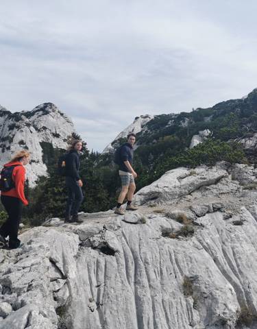Hikers on a rocky mountain trail.