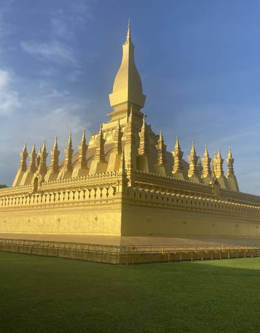 Golden temple complex under a blue sky