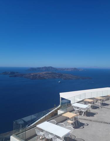 Scenic view of the sea with islands and boats, as seen from a balcony.