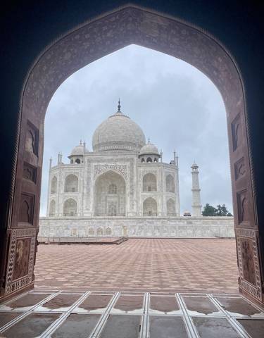 Close-up of the Taj Mahal facade through an archway.