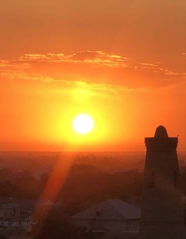 Silhouette of a tower against a vibrant sunset