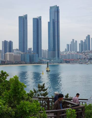 View of a coastal city with high-rise buildings by the water.